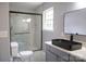 Modern bathroom featuring a marbled shower and black vessel sink with gold finishes at 830 Mcarthur Ave, Charlotte, NC 28206