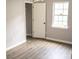 Bedroom with wood-look floors, neutral paint, and a closet at 830 Mcarthur Ave, Charlotte, NC 28206