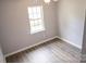 Bedroom featuring wood-look floors and a window at 830 Mcarthur Ave, Charlotte, NC 28206