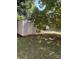 Backyard shed with a door, nestled under a shady tree at 830 Mcarthur Ave, Charlotte, NC 28206