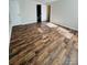 Spacious bedroom featuring wood-look flooring and an ensuite bathroom entrance at 9541 Shannon Green Dr, Charlotte, NC 28213