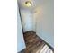 Hallway with wood-look flooring and neutral wall paint leading to the front door at 9541 Shannon Green Dr, Charlotte, NC 28213