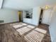 Open living space with a view of the kitchen and wood-style flooring at 9541 Shannon Green Dr, Charlotte, NC 28213