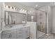 Stylish bathroom with double vanity, modern shower, and neutral tile at 9620 Ainslie Downs St, Charlotte, NC 28273