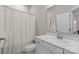 This bathroom features a shower with a white shower curtain, and a vanity at 9620 Ainslie Downs St, Charlotte, NC 28273