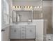 Modern bathroom with double vanity, sleek mirror, shower with glass enclosure and light fixtures at 9620 Ainslie Downs St, Charlotte, NC 28273