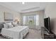 Comfortable bedroom features a tray ceiling, plush carpet, and large windows at 9620 Ainslie Downs St, Charlotte, NC 28273