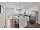 Bright kitchen with white cabinets, stainless steel appliances, and a granite island at 9620 Ainslie Downs St, Charlotte, NC 28273