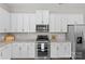 Well-equipped kitchen with stainless steel appliances, white cabinets, and granite countertops at 9620 Ainslie Downs St, Charlotte, NC 28273