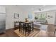 The open floor plan features a bar-height table and a view into the adjacent living room at 9620 Ainslie Downs St, Charlotte, NC 28273
