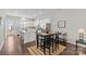 The open floor plan features a bar-height table and a view into the adjacent living room at 9620 Ainslie Downs St, Charlotte, NC 28273