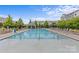 Beautiful community pool with ample seating, landscaping, and a gazebo at 9620 Ainslie Downs St, Charlotte, NC 28273