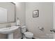 This powder room features a pedestal sink and neutral colors at 9620 Ainslie Downs St, Charlotte, NC 28273