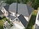 Aerial view of the house showcasing well-maintained roof, landscaping, and a two car garage at 9792 Ravenscroft Nw Ln, Concord, NC 28027