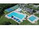 Aerial shot showcasing a full community center with a pool, tennis courts, and clubhouse at 9792 Ravenscroft Nw Ln, Concord, NC 28027