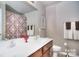 A well-lit bathroom features a double sink vanity and decorative floral patterned shower curtain at 9792 Ravenscroft Nw Ln, Concord, NC 28027