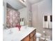 Bathroom with double vanity sinks, framed mirror, and patterned shower curtain at 9792 Ravenscroft Nw Ln, Concord, NC 28027