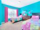 Colorful bedroom with two twin beds and bright pink curtains at 9792 Ravenscroft Nw Ln, Concord, NC 28027