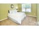 Cozy bedroom with natural light and neutral decor, creating a relaxing atmosphere at 9792 Ravenscroft Nw Ln, Concord, NC 28027