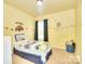 Bright, yellow bedroom showcasing car themed wall decor and a twin bed at 9792 Ravenscroft Nw Ln, Concord, NC 28027