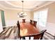 Formal dining room with hardwood floors, a chandelier and decorative wall trim at 9792 Ravenscroft Nw Ln, Concord, NC 28027