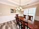Formal dining room with hardwood floors, a chandelier and decorative wall trim at 9792 Ravenscroft Nw Ln, Concord, NC 28027