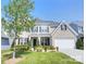 Charming two-story home with brick and siding exterior, manicured lawn, and well-maintained landscaping at 9792 Ravenscroft Nw Ln, Concord, NC 28027