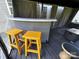 The inviting outdoor bar area with barstools inside of the covered gazebo at 9792 Ravenscroft Nw Ln, Concord, NC 28027