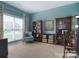 This home office features carpet, multiple bookshelves, and a cozy chair at 9792 Ravenscroft Nw Ln, Concord, NC 28027