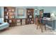 This home office features carpet, multiple bookshelves, and a cozy chair at 9792 Ravenscroft Nw Ln, Concord, NC 28027
