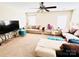 Bright living room featuring plush furniture, neutral carpeting and a ceiling fan at 9792 Ravenscroft Nw Ln, Concord, NC 28027