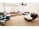 Spacious living room with neutral carpeting, ceiling fan, and lots of furniture at 9792 Ravenscroft Nw Ln, Concord, NC 28027
