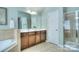 Bright bathroom with double vanities, tiled floors, soaking tub, and a separate shower at 9792 Ravenscroft Nw Ln, Concord, NC 28027