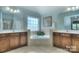 Bright bathroom with double vanities, soaking tub, and separate shower at 9792 Ravenscroft Nw Ln, Concord, NC 28027