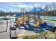 Bright and colorful playground featuring slides and climbing structures set against a sunny blue sky at 9792 Ravenscroft Nw Ln, Concord, NC 28027