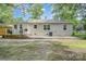 Image shows the back of the brick home with a brick patio area at 1006 Home Trl, Gastonia, NC 28052