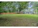 Large backyard with mature trees, new privacy fence, and patio at 1006 Home Trl, Gastonia, NC 28052
