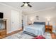 This bedroom has a ceiling fan, wood floors, and warm-toned wooden furniture for storage at 1006 Home Trl, Gastonia, NC 28052