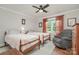 Bedroom with two twin beds, gray armchair and neutral carpet with a ceiling fan at 1006 Home Trl, Gastonia, NC 28052
