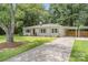 Brick ranch home with large driveway, carport, and landscaped yard at 1006 Home Trl, Gastonia, NC 28052
