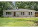Charming brick ranch home with manicured lawn and mature trees at 1006 Home Trl, Gastonia, NC 28052