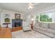 Inviting living room with fireplace, hardwood floors, and natural light at 1006 Home Trl, Gastonia, NC 28052