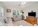 Cozy living room featuring hardwood floors, neutral paint, and natural light at 1006 Home Trl, Gastonia, NC 28052