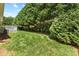 Expansive backyard featuring lush greenery, trees, and an attached deck at 1011 Atherstone Nw St, Conover, NC 28613