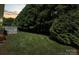 Lush backyard featuring vibrant greenery, mature trees, and outdoor deck at 1011 Atherstone Nw St, Conover, NC 28613