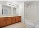 Bathroom featuring double sinks, tile flooring, and shower-tub combo at 1011 Atherstone Nw St, Conover, NC 28613
