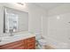 Bathroom features tile floors, vanity with sink, and tub with shower at 1011 Atherstone Nw St, Conover, NC 28613