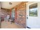 Inviting front porch with traditional brickwork and a comfortable seating area at 1011 Atherstone Nw St, Conover, NC 28613