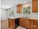 Kitchen with wood cabinets, stainless steel sink, and hardwood-floored dining area at 1011 Atherstone Nw St, Conover, NC 28613
