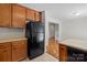 Kitchen features wood cabinets and black refrigerator, with tile flooring at 1011 Atherstone Nw St, Conover, NC 28613